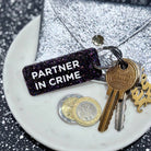 PARTNER IN CRIME Porte-clés à paillettes Plus de Love: Noir