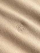 GABadriel Pull demi-zip en maille Lume, col montant — Gabba — Sand Crocker — détail de la broderie 4 | Appart 17 Bruxelles