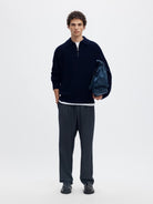 SLMBEN Pull col polo zippé en laine RWS — Selected Homme — Sky Captain — porté, en pied avec sac 3 | Appart 17 Bruxelles